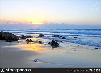 Natural rocks at Praia Vale Figueiras in Portugal at twilight