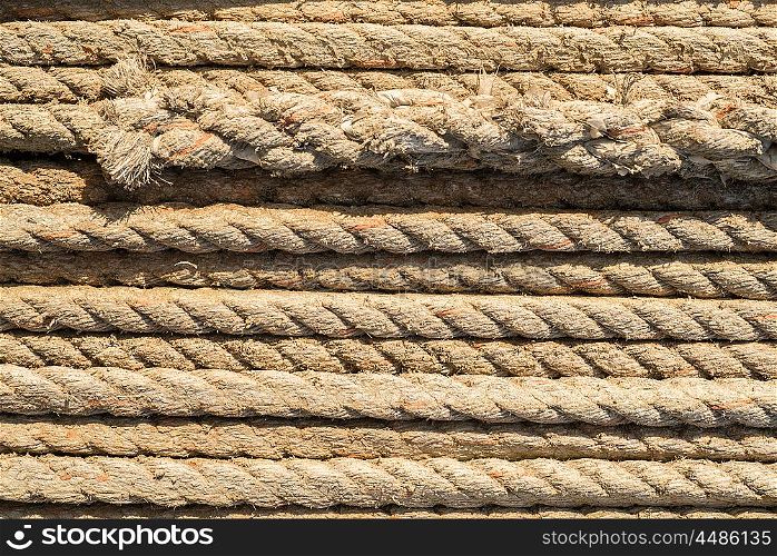 Natural rope made of fibre as background with knot in foreground.