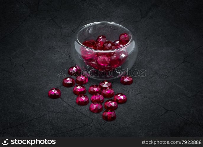 Natural rubies on the cracked dark gray background.