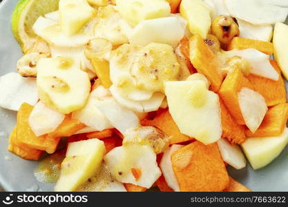 Natural salad with juicy apple,carrot and Jerusalem artichoke.Healthy food. Vitamin salad with vegetables and fruits