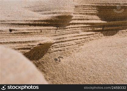 Natural sandstone texture background, wall cut on a sand dune or dune, sandy background for summer designs or backgrounds.