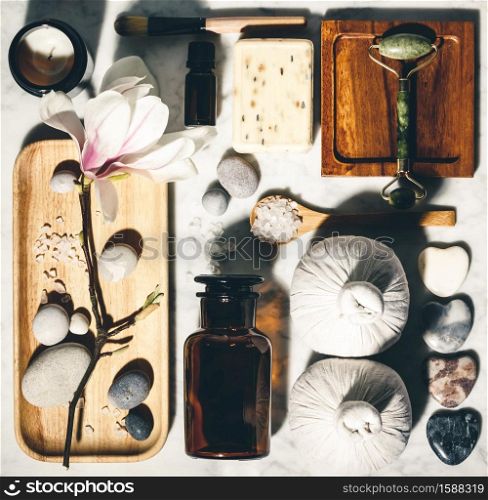 Natural skin care products with spring magnolia flower flat lay. Zero waste, eco friendly bathroom and spa accessories