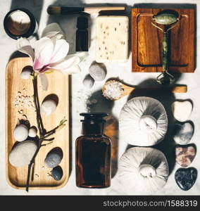 Natural skin care products with spring magnolia flower flat lay. Zero waste, eco friendly bathroom and spa accessories