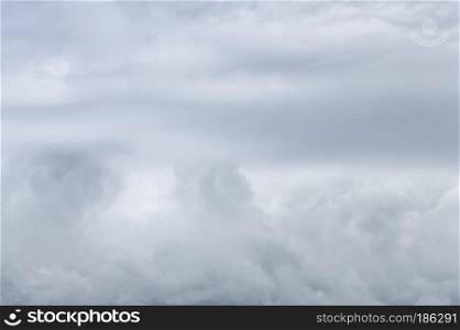 Natural sky background - a texture of white and gray cumulus clouds before a thunderstorm. Soft selective focus, space for copy.. Natural Sky Background Of Gray And White Clouds