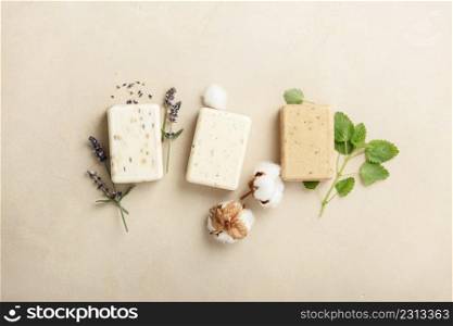 Natural soap bars and ingredients- lavender, cotton, patchouli - on natural stone background, top view. Handmade organic DIY soap, Zero waste cosmetics concept