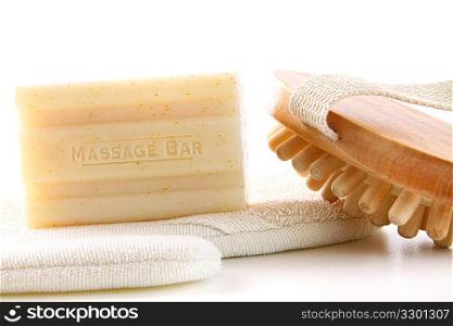 Natural soap with bath accessories on white