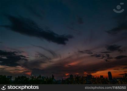 Natural Sunset in evening downtown silhouette at bangkok. Bright Dramatic Sky And Dark Ground. city Landscape Under Scenic Colorful Sky At Sunset. Sun Over Skyline, Horizon. Light blue background. copy space.