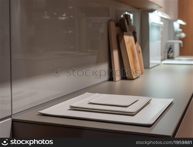Natural Tone Kitchen Counter with Square Flat Plates and Wooden Chopping Boards