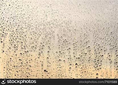 Natural water drops and sunlight on glass, closeup texture
