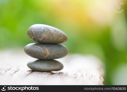 Natural wellness concept / Relax zen stones stack on wooden nature green background Spa Natural Alternative Therapy With Massage Stones