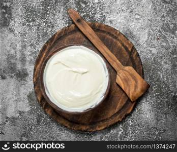 Natural yogurt in a bowl. On a rustic background.. Natural yogurt in a bowl.