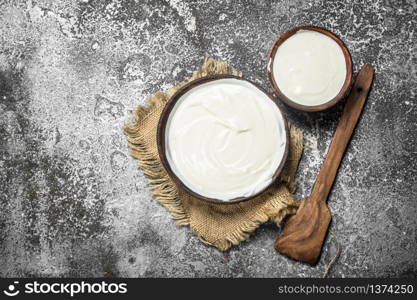 Natural yogurt in a bowl. On a rustic background.. Natural yogurt in a bowl.