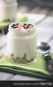 Natural yogurt with fresh berries and grains