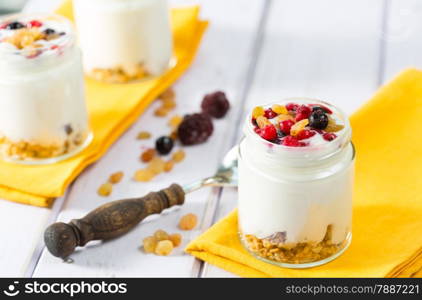 Natural yogurt with fresh berries and grains