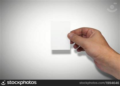 Naturally groomed male hand holding a blank white business card. Room for copy.