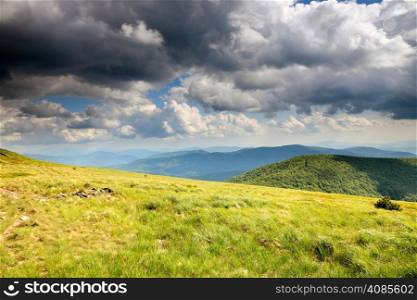 Nature and environment. Fields and hills. Mountain landscape in the summer. Travel and tourism.