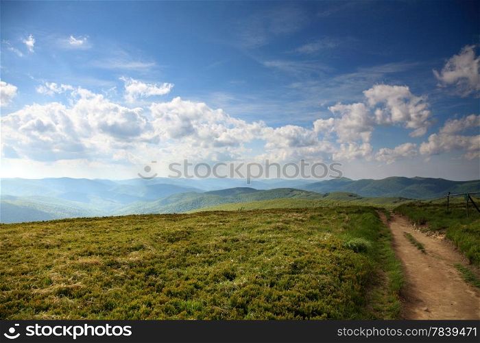 Nature and environment. Road in the beautiful green hills. Mountain landscape in the summer. Travel and tourism.