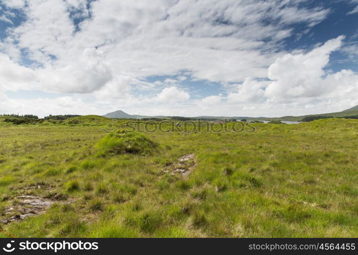 nature and landscape concept - view to plain with lake or river at connemara in ireland. view to plain and lake at connemara in ireland