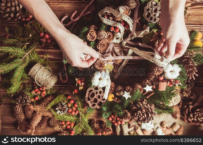 Nature components wreath - preparation for making natural eco decorations. Focus on hands. Nature wreath making