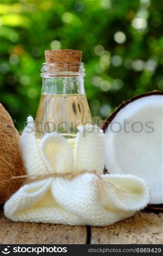 Nature cosmetic products, coconut oil from copra in glass jar on green background, essential oil for skin care, rich vitamin, organic cosmetic also massage oil at spa