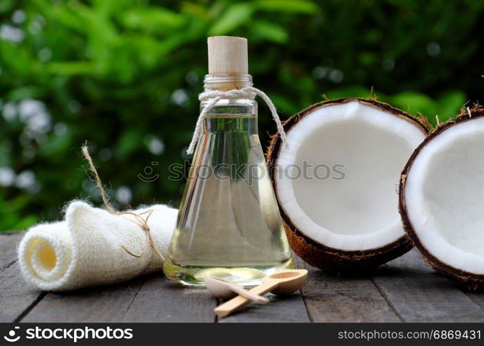 Nature cosmetic products, coconut oil from copra in glass jar on green background, essential oil for skin care, rich vitamin, organic cosmetic also massage oil at spa