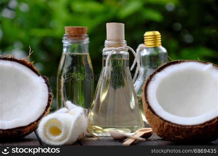 Nature cosmetic products, coconut oil from copra in glass jar on green background, essential oil for skin care, rich vitamin, organic cosmetic also massage oil at spa