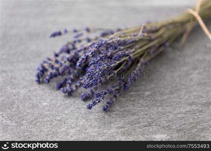 nature, flora and herbal concept - bunch of dried lavender flowers on stone surface. bunch of dried lavender flowers on stone surface