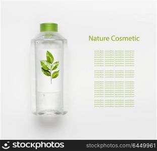 Nature herbal cosmetic concept. Transparent liquid bottle of toner, micellar water or cleansing product with green leaves and branding mock up on white desk background , top view.