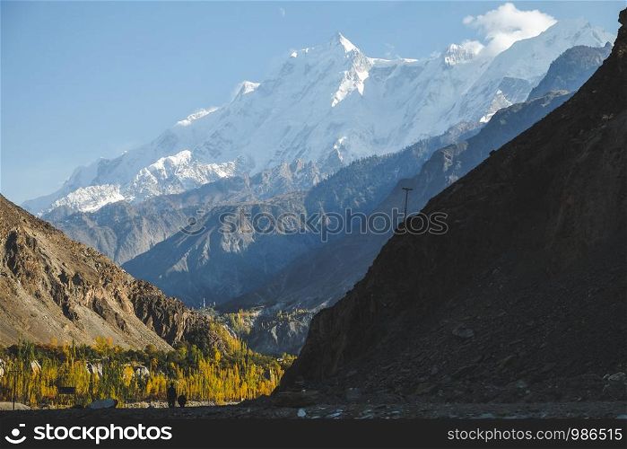 Nature landscape view of snow capped Rakaposhi peak in Karakoram mountain range in Nagar valley. Autumn scenery in Gilgit Baltistan, Pakistan.
