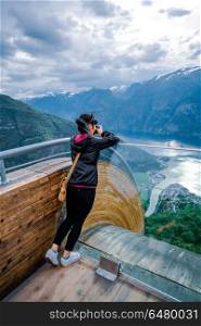 Nature photographer. Stegastein Lookout.. Nature photographer tourist with camera shoots. Stegastein Lookout. Beautiful Nature Norway.