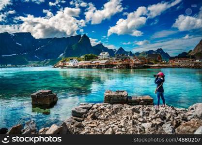 Nature photographer tourist with camera shoots Lofoten archipelago islands Norway. Beautiful Nature Norway.