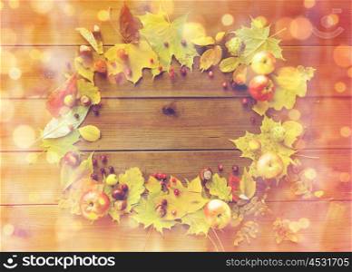 nature, season, advertisement and decor concept - set of autumn leaves, fruits and berries on wooden table