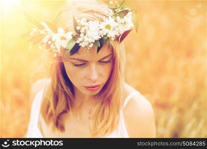 nature, summer holidays, vacation and people concept - face of happy woman in wreath of flowers. happy woman in wreath of flowers. happy woman in wreath of flowers