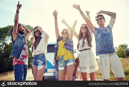 nature, summer, youth culture and people concept - happy young hippie friends dancing over minivan car outdoors