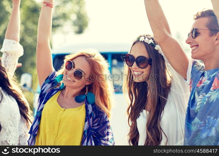 nature, summer, youth culture and people concept - happy young hippie friends dancing over minivan car outdoors