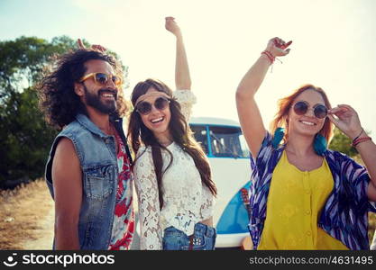 nature, summer, youth culture and people concept - happy young hippie friends dancing over minivan car outdoors