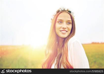 nature, summer, youth culture and people concept - smiling young hippie woman wearing flower wreath on cereal field. smiling young hippie woman on cereal field
