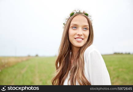 nature, summer, youth culture and people concept - smiling young hippie woman wearing flower wreath on cereal field