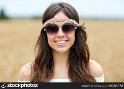 nature, summer, youth culture and people concept - smiling young hippie woman in sunglasses outdoors