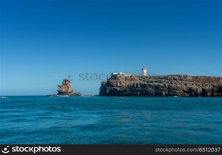Nau dos Corvos and the Lighthouse of Peniche, Portugal. View from the ocean. Nau dos Corvos