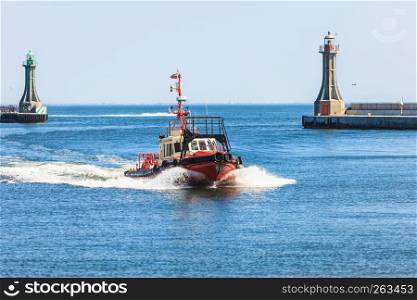 Naval maritime sailing concept. Small vessel eturning to port. Little tug boat returning from sea.. Small vessel returning to port.