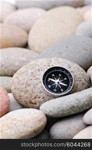 Navigation compass on stone pebbles
