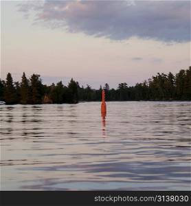 Navigational buoy in the middle of a lake, Lake of the Woods, Ontario, Canada