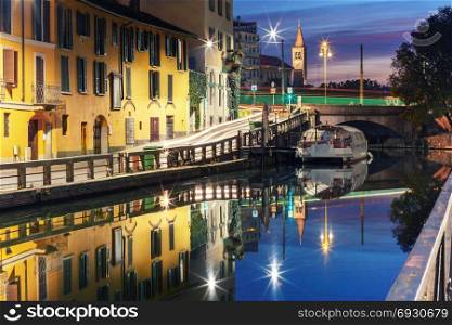 Naviglio Grande canal in Milan, Lombardia, Italy. Bridge across the Naviglio Grande canal at sunrise, Milan, Lombardia, Italy