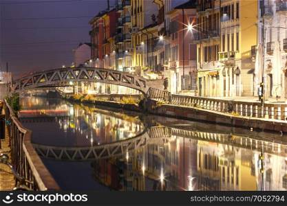 Naviglio Grande canal in Milan, Lombardia, Italy. Bridge across the Naviglio Grande canal at night, Milan, Lombardia, Italy