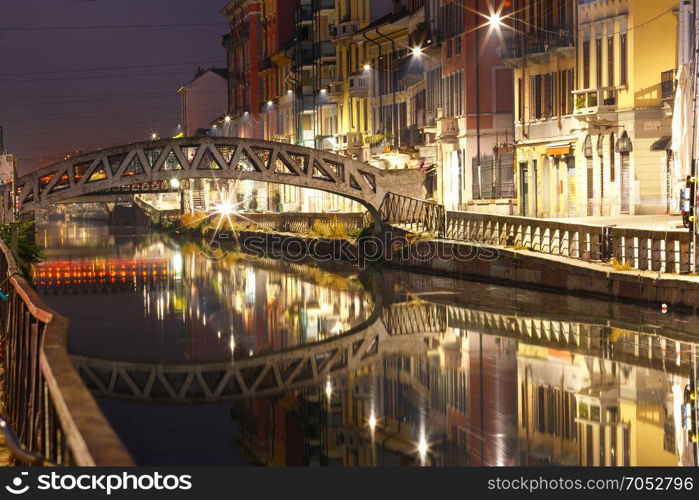 Naviglio Grande canal in Milan, Lombardia, Italy. Bridge across the Naviglio Grande canal at night, Milan, Lombardia, Italy