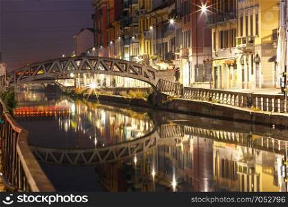 Naviglio Grande canal in Milan, Lombardia, Italy. Bridge across the Naviglio Grande canal at night, Milan, Lombardia, Italy