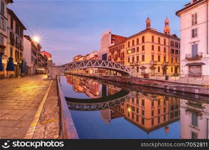 Naviglio Grande canal in Milan, Lombardia, Italy. Bridge across the Naviglio Grande canal during morning blue hour, Milan, Lombardia, Italy