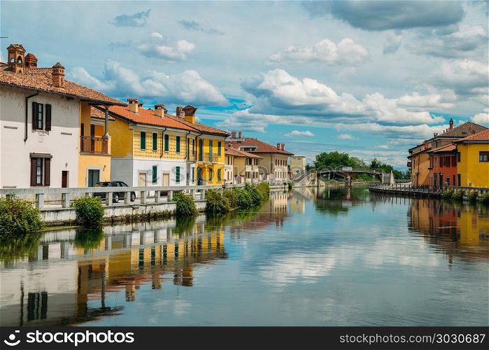 Naviglio Grande canal waterway passes near the historic and colorful buildings of Gaggiano Italy. Naviglio Grande canal waterway passes near the historic and colorful buildings of Gaggiano Italy.