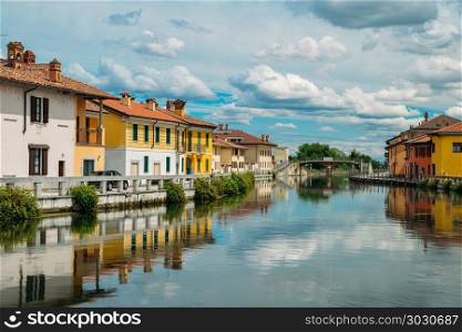 Naviglio Grande canal waterway passes near the historic and colorful buildings of Gaggiano Italy. Naviglio Grande canal waterway passes near the historic and colorful buildings of Gaggiano Italy.